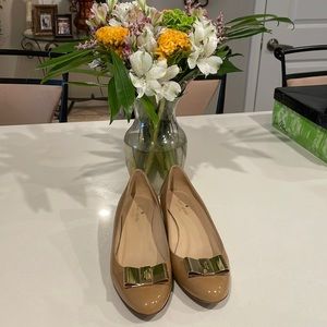 Kate Spade paten leather nude wedge/ with gold bow detail.
